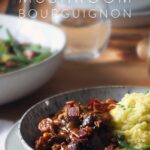 Pinterest pin for vegan mushroom bourguignon showing the finished dish with a text overlay.